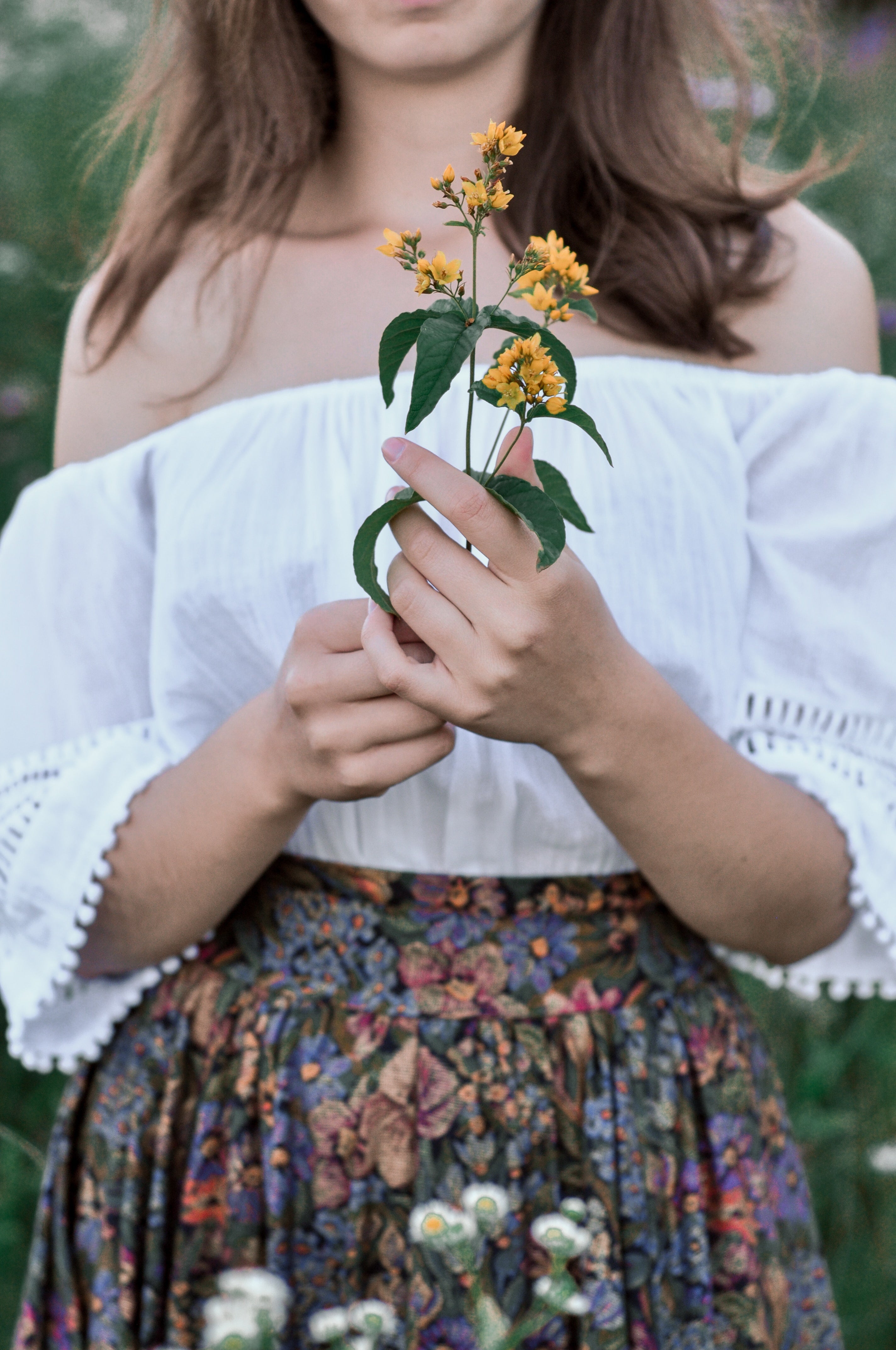 Photo by <a href="https://unsplash.com/@gingermias?utm_content=creditCopyText&utm_medium=referral&utm_source=unsplash">S L</a> on <a href="https://unsplash.com/photos/woman-in-white-floral-dress-holding-yellow-flower-fRJ_MeDH7C8?utm_content=creditCopyText&utm_medium=referral&utm_source=unsplash">Unsplash</a>   